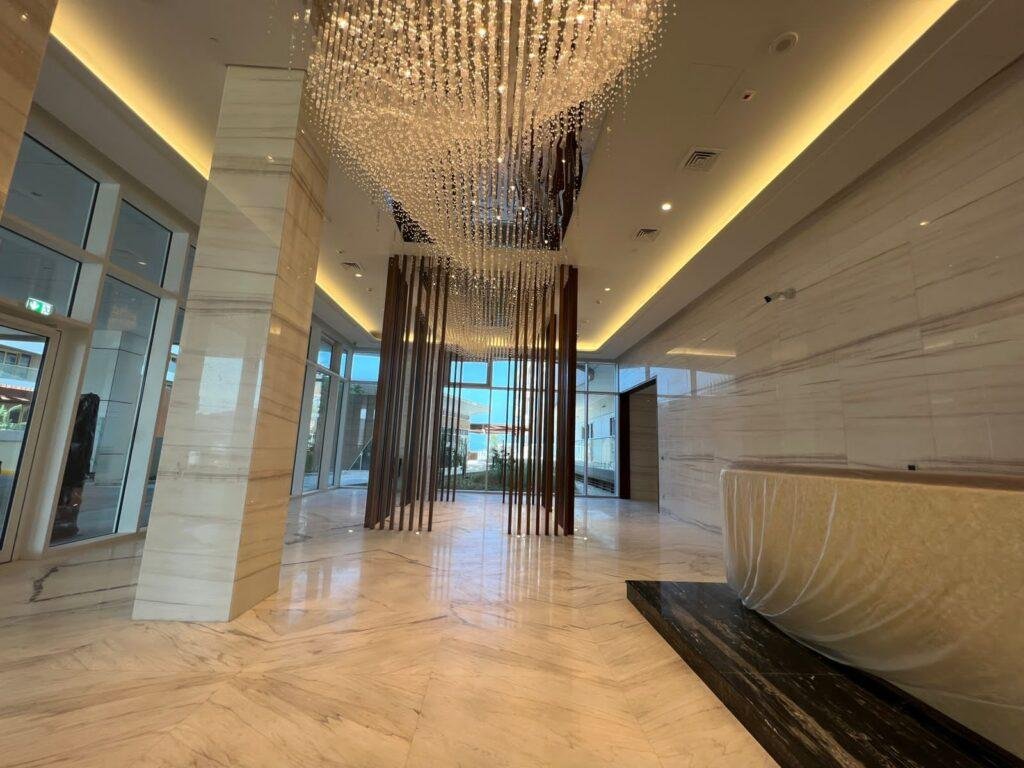 Sunset view of Qaryat Al Hidd waterfront community with premium residences and lush greenery on Saadiyat Island.